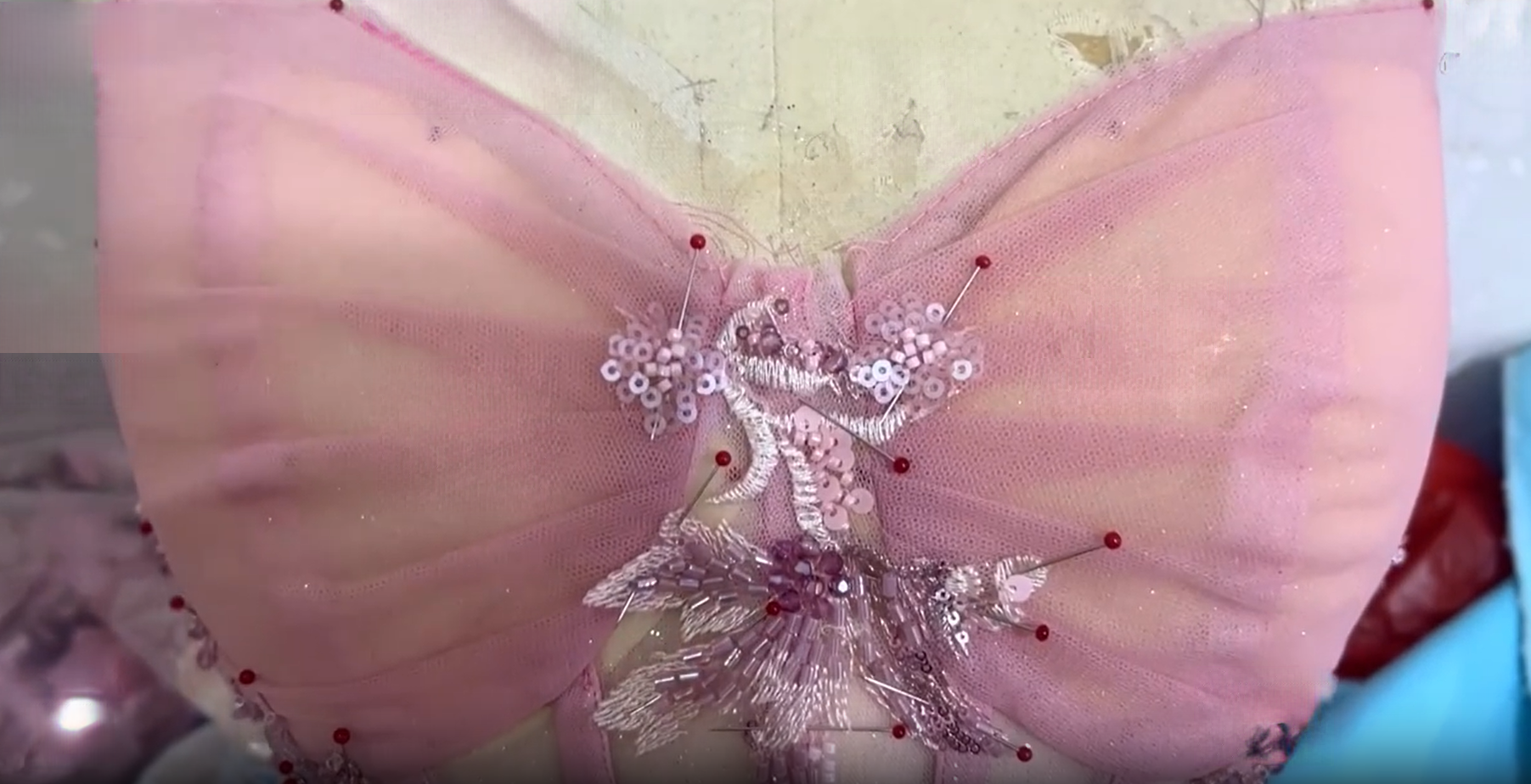 Assembling voluminous tulle layers for blush pink ball gown Assembling voluminous tulle layers for blush pink ball gown