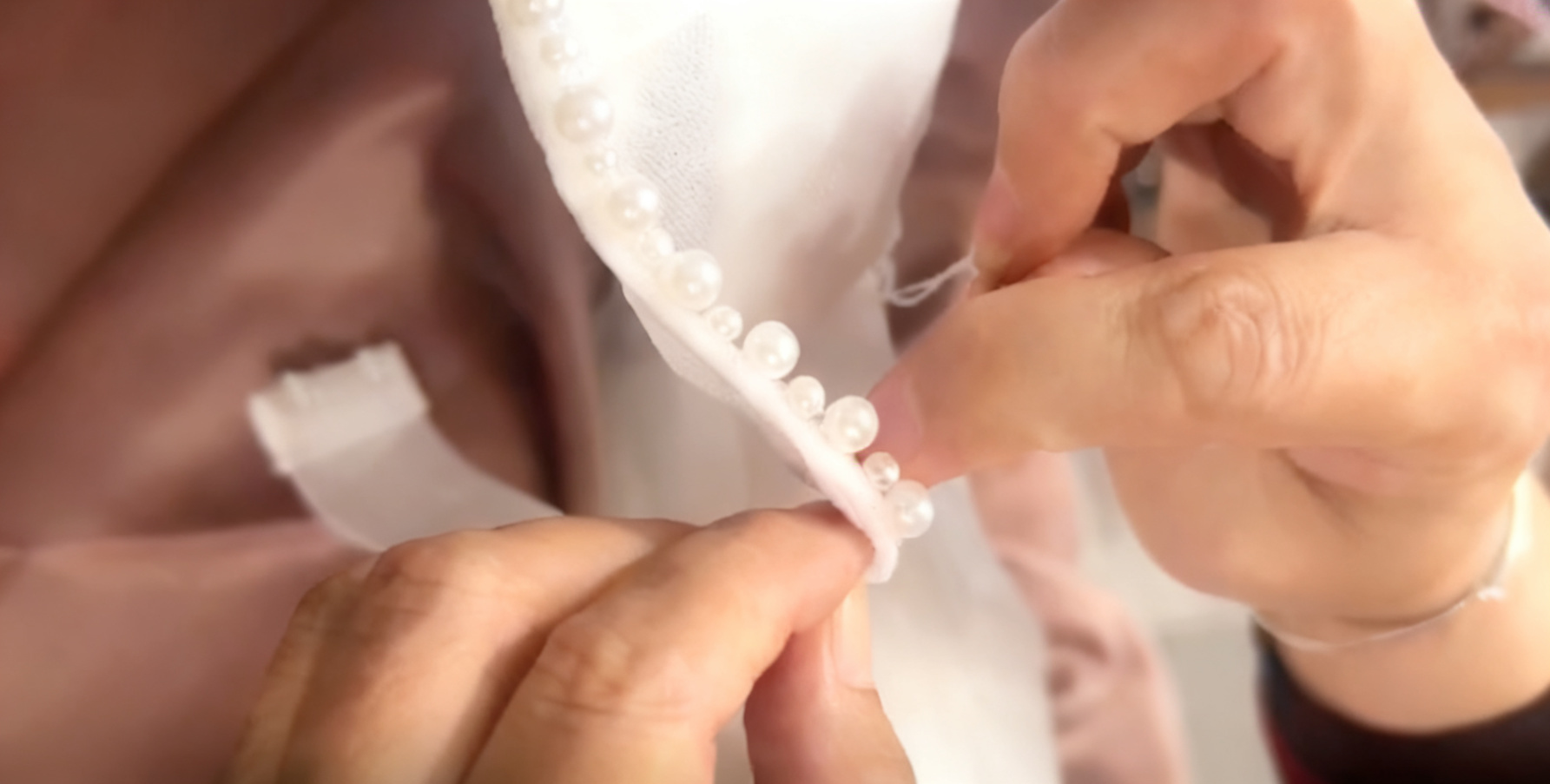 Elegant bride wearing pearl embellished mermaid wedding gown with flowing cape Elegant bride wearing pearl embellished mermaid wedding gown with flowing cape